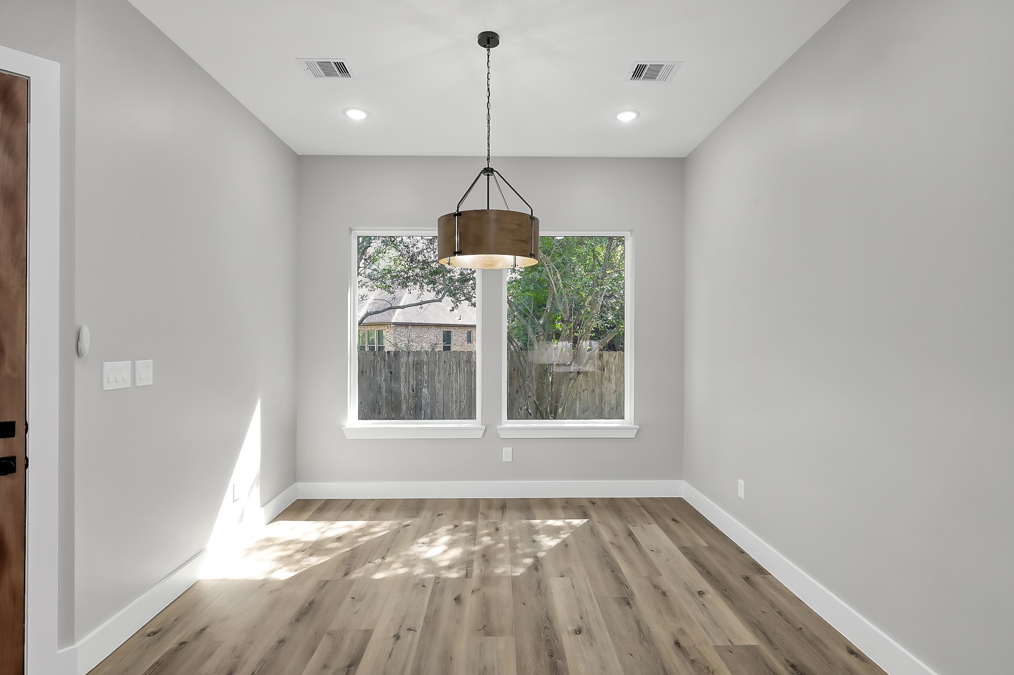 135 Wick Willow Road Montgomery, TX 77356 - Photo 22 of 50 a view of an empty room with wooden floor and a window