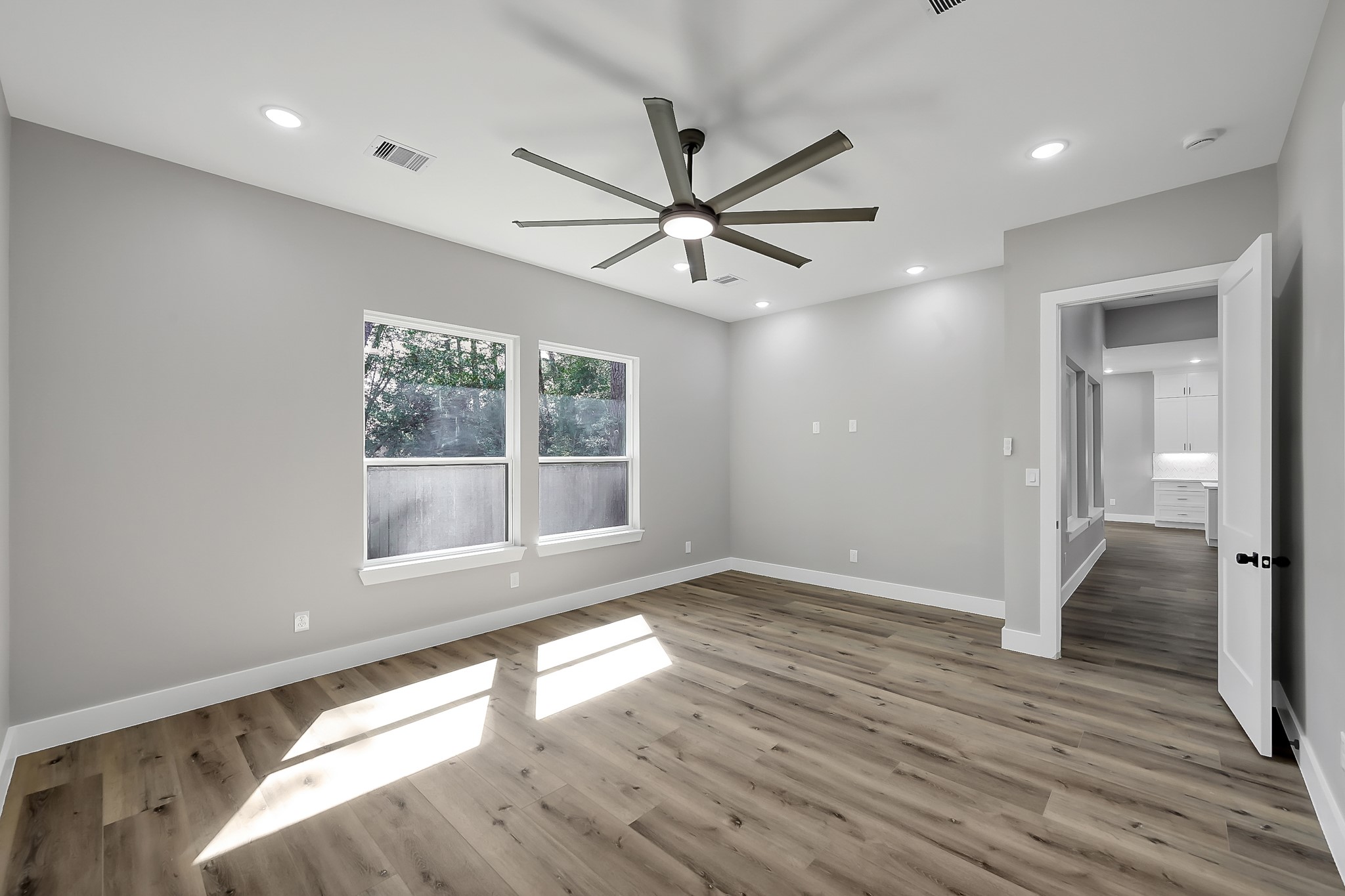 135 Wick Willow Road Montgomery, TX 77356 - Photo 24 of 50 a view of an empty room with wooden floor and a window