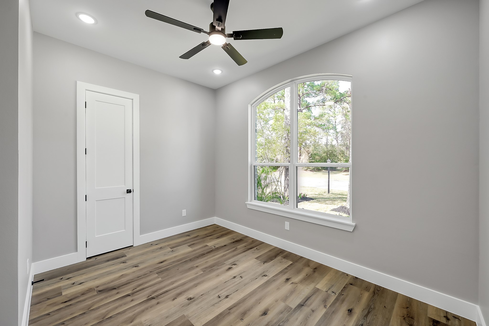 135 Wick Willow Road Montgomery, TX 77356 - Photo 32 of 50 a view of an empty room with wooden floor and a window