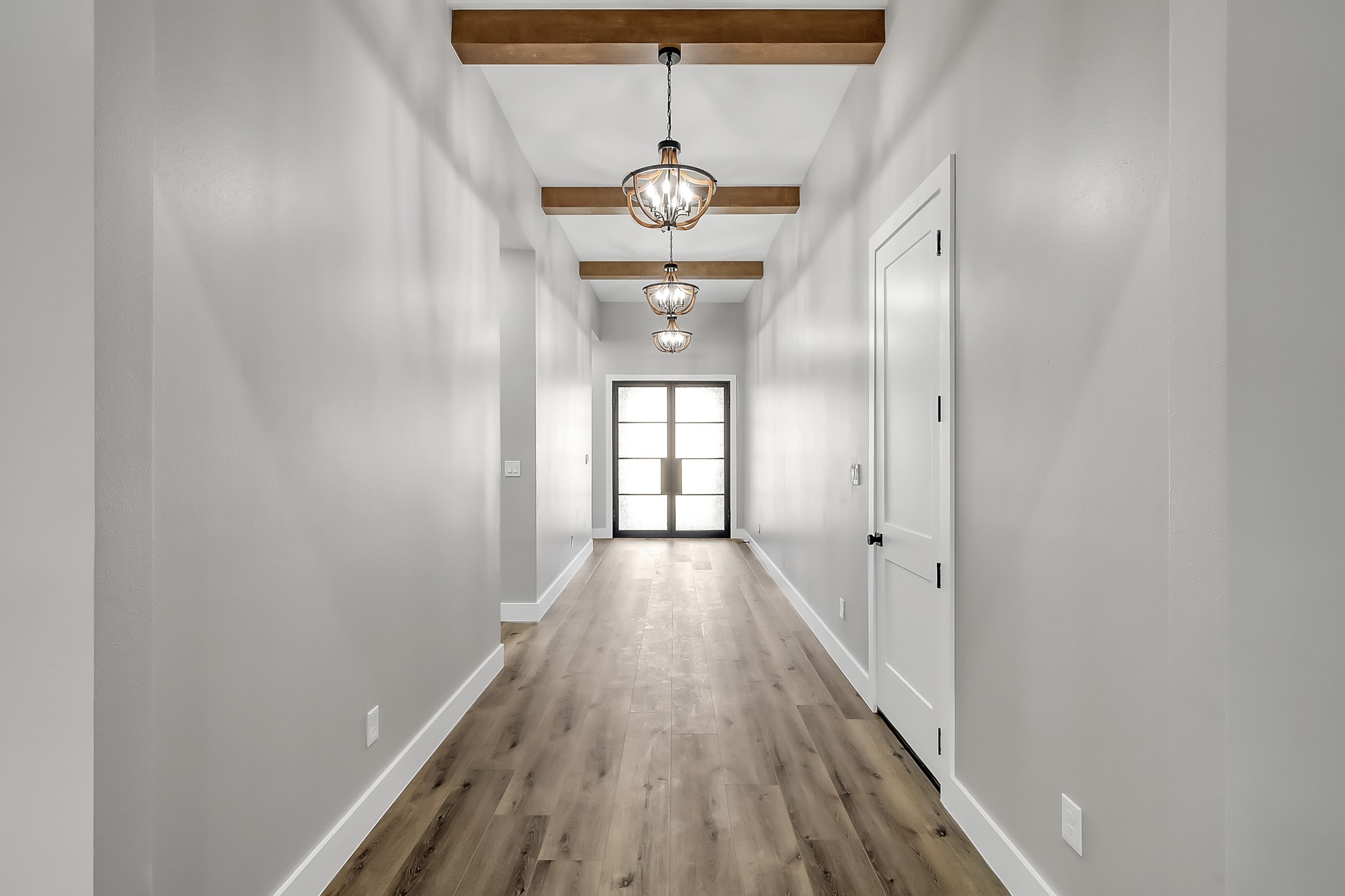 135 Wick Willow Road Montgomery, TX 77356 - Photo 5 of 50 a view of a hallway with wooden floor and chandelier