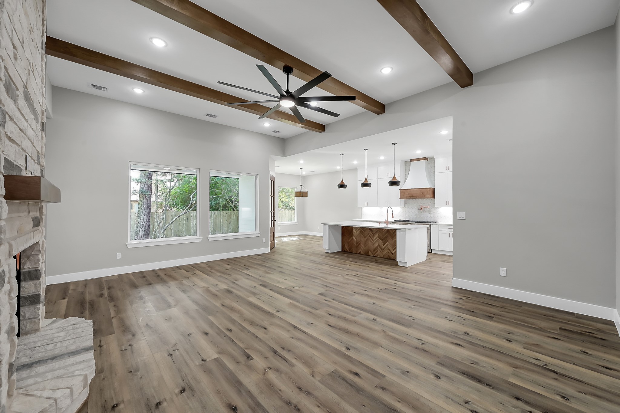135 Wick Willow Road Montgomery, TX 77356 - Photo 8 of 50 a view of an empty room with wooden floor and a window