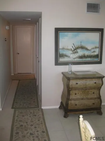 a view of a hallway with paintings on the wall