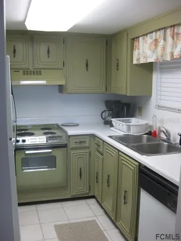a kitchen with stainless steel appliances granite countertop a sink and a stove