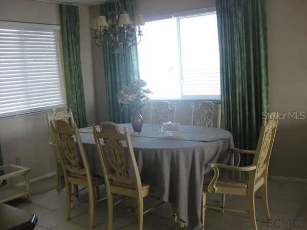 a dining room with furniture and window