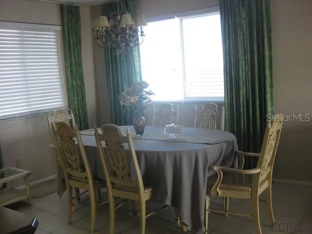 a dining room with furniture and window