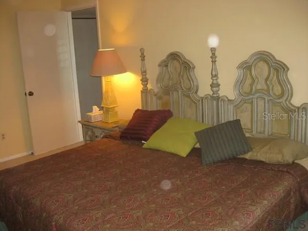 a bedroom with a bed and a lamp