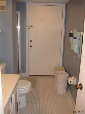 a white toilet sitting next to a bathroom sink
