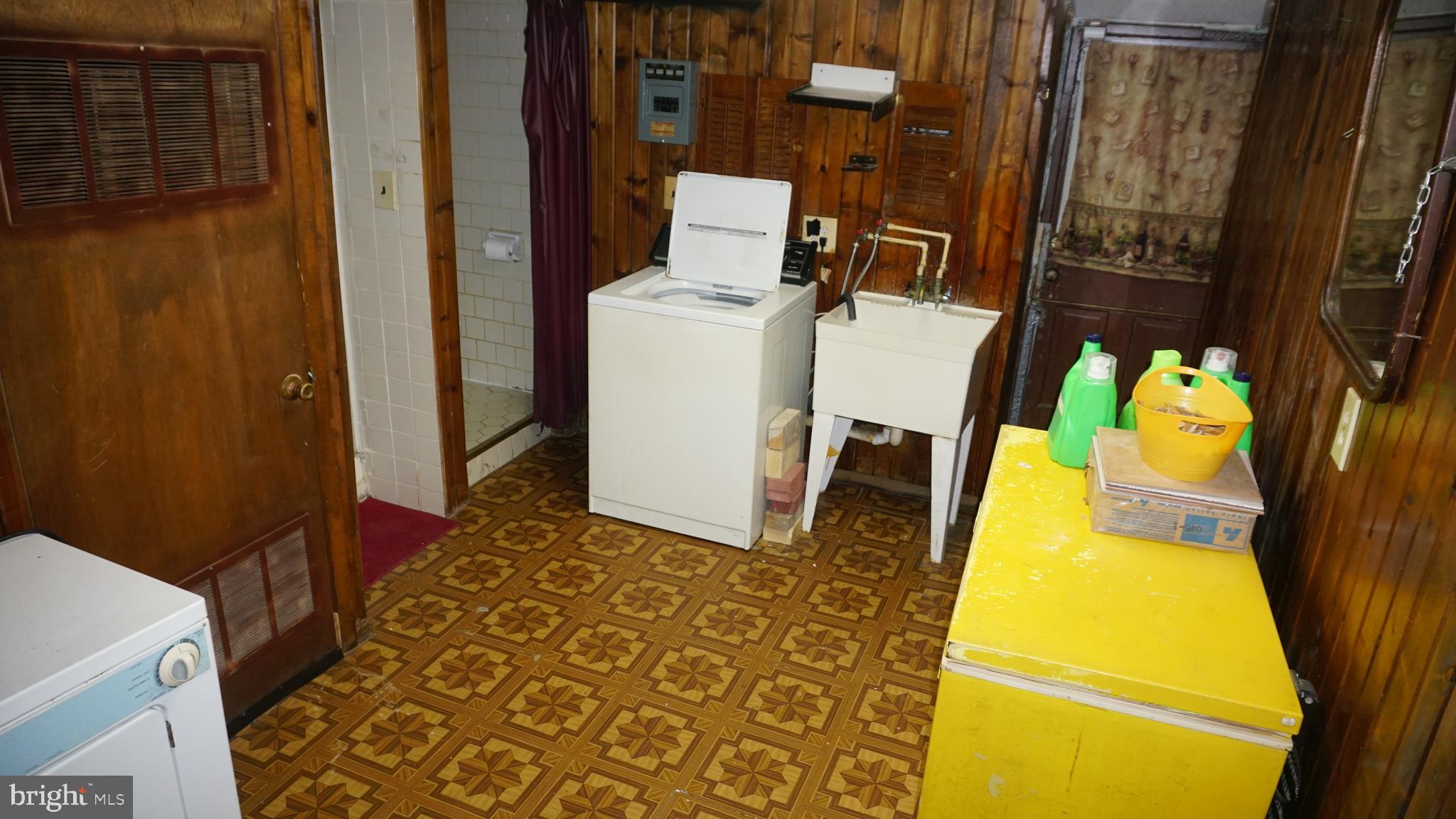 3005 Belair Road Baltimore, MD 21213 - Photo 27 of 33 a bathroom with a sink and mirror with bathtub