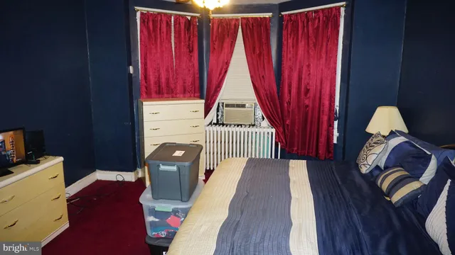 a bedroom with a bed and window