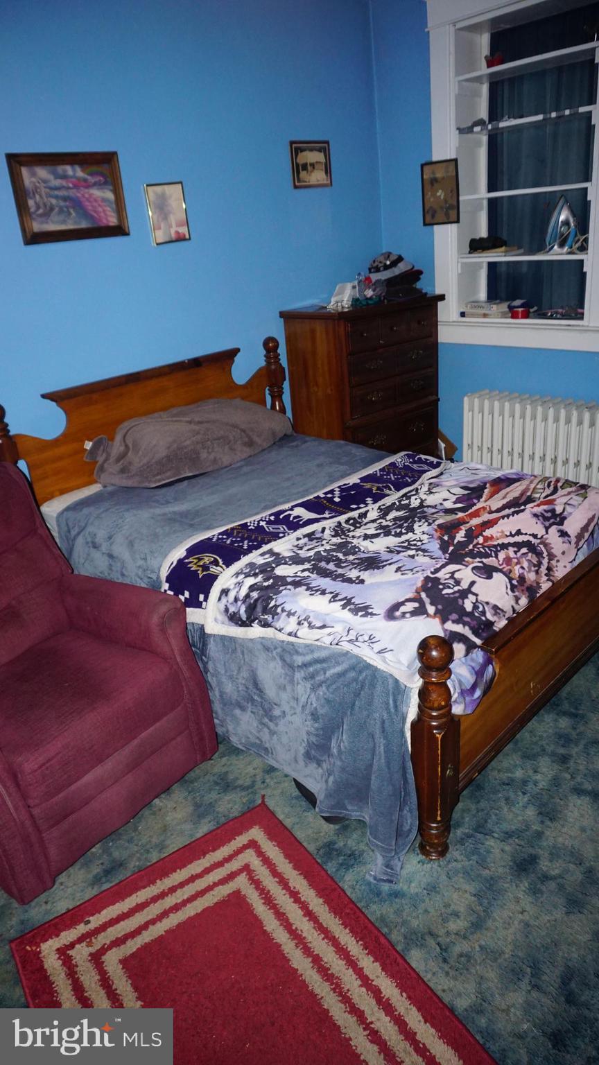 3005 Belair Road Baltimore, MD 21213 - Photo 32 of 33 a bedroom with bed and dresser