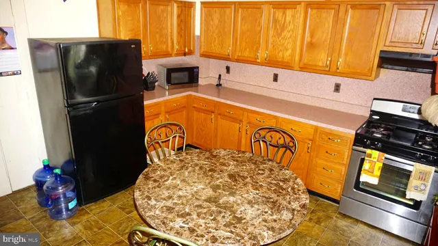 a view of a kitchen with a refrigerator and window