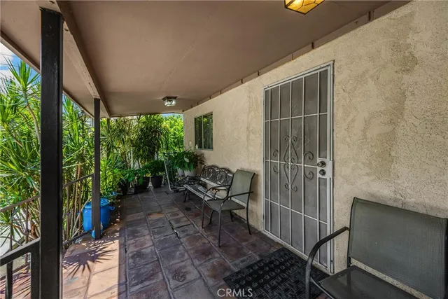 a view of a patio with table and chairs next to a yard