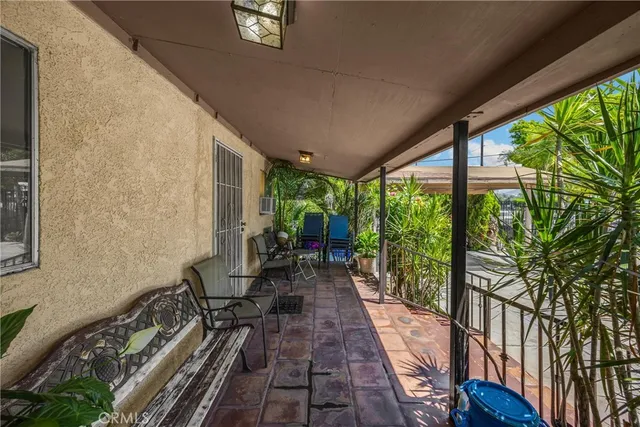 a view of a house with swimming pool and sitting area