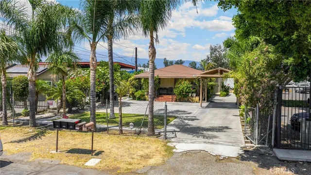 a view of a patio with table and chairs under an umbrella
