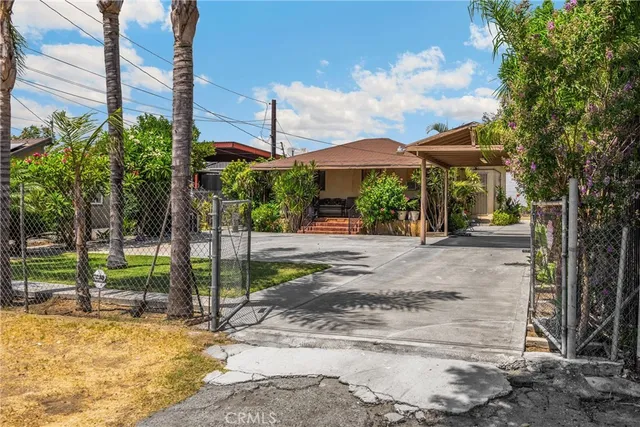 a view of a street with potted plants