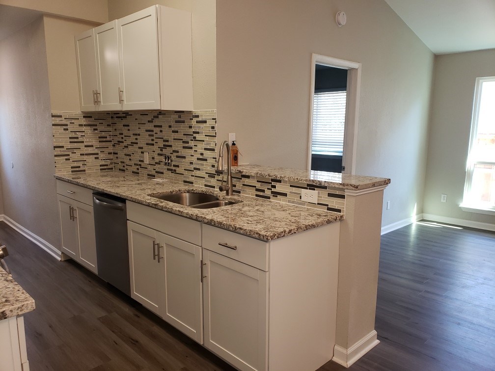 2302 Fuzz Fairway, Unit B Austin, TX 78728 - Photo 7 of 27 Kitchen with breakfast bar looks into living area with high ceilings and tons of natural light.