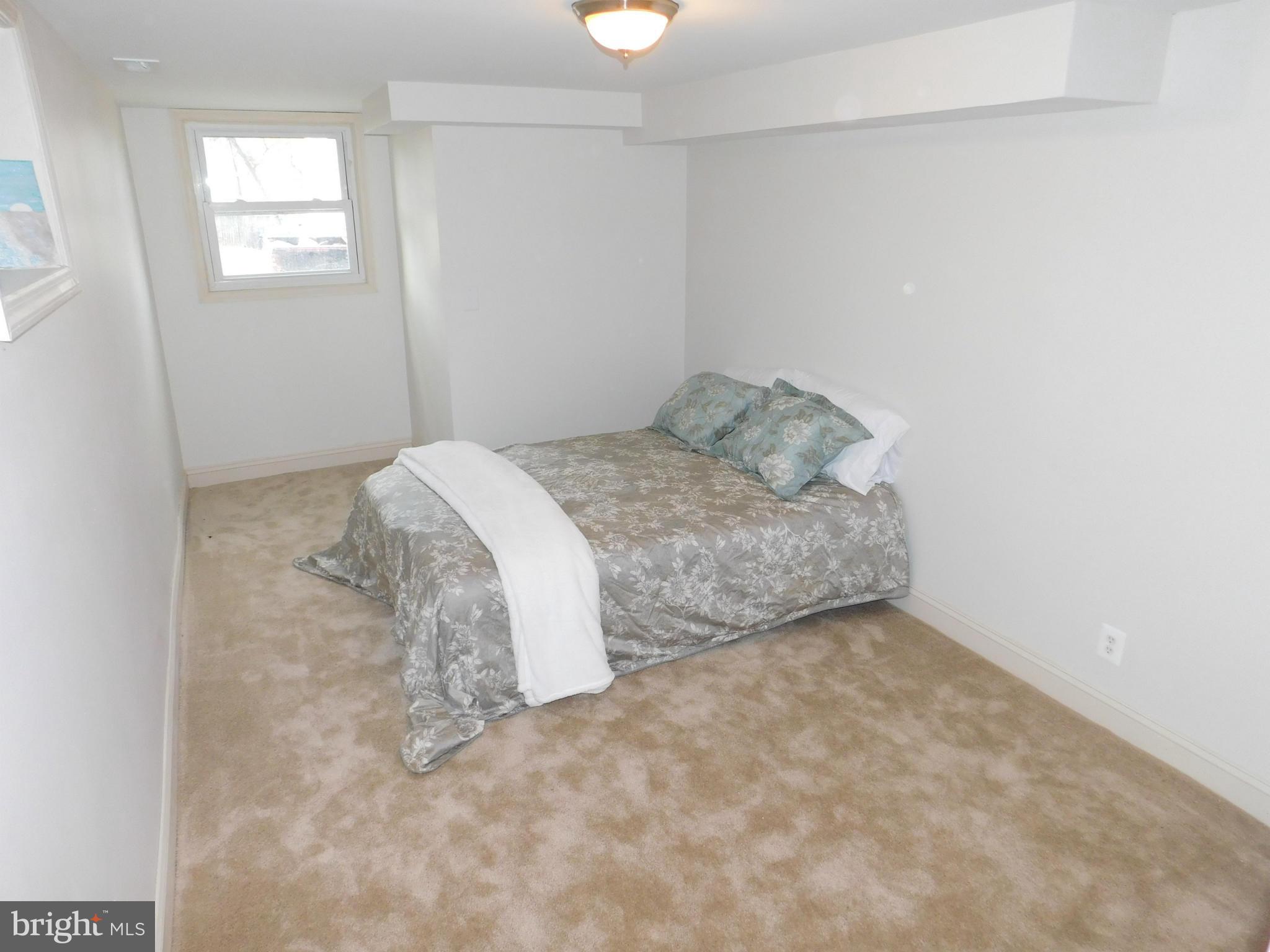 15 Summerfield Road Baltimore, MD 21207 - Photo 14 of 16 a bedroom with a bed and a window