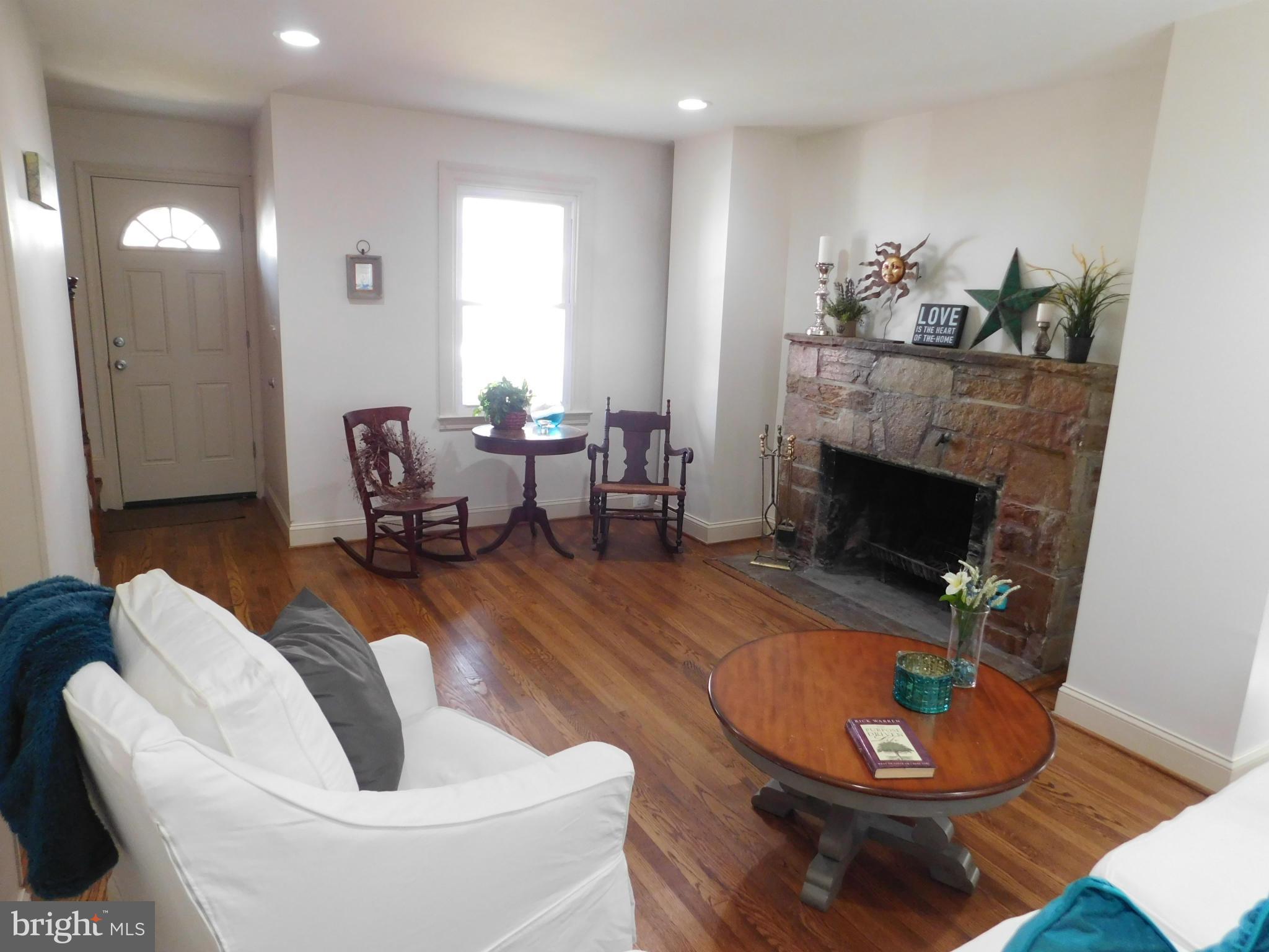15 Summerfield Road Baltimore, MD 21207 - Photo 3 of 16 a living room with furniture and a fireplace