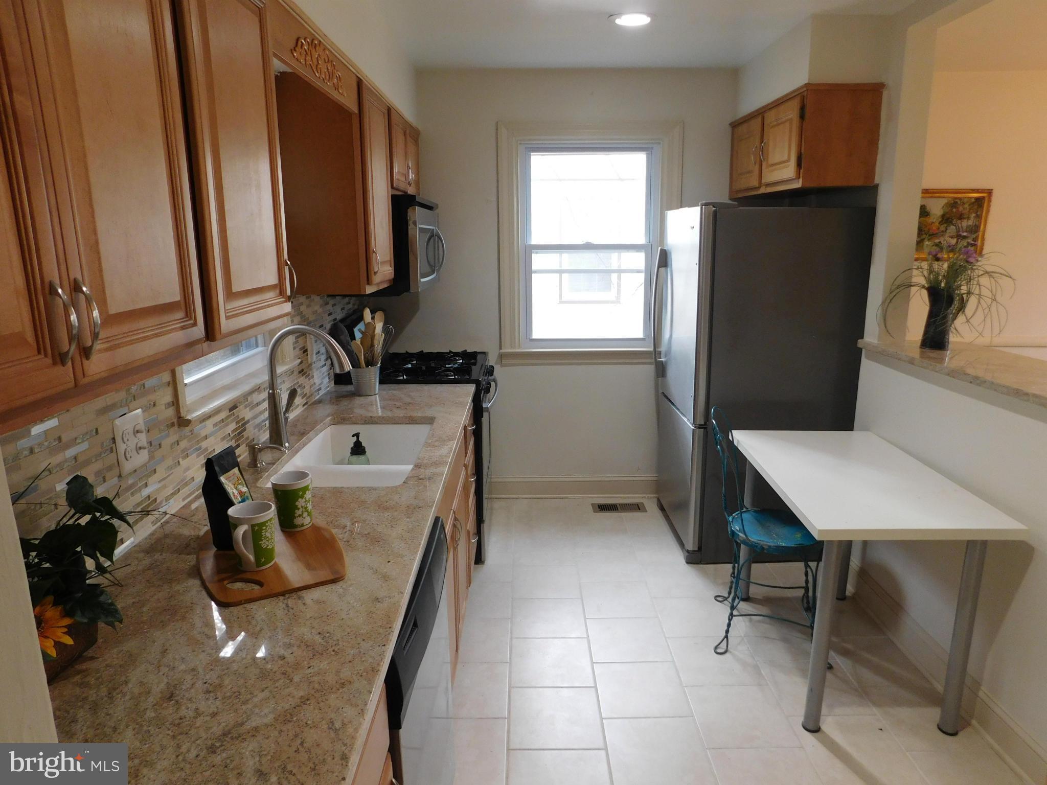 15 Summerfield Road Baltimore, MD 21207 - Photo 7 of 16 a bathroom with a sink a toilet and a mirror