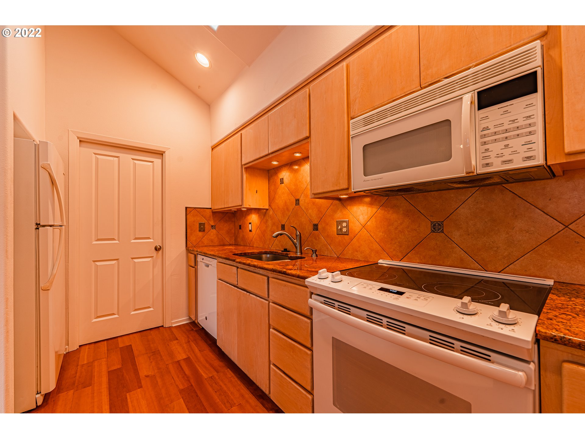 975 Sunset Drive Springfield, OR 97477 - Photo 11 of 30 a kitchen with stainless steel appliances granite countertop a stove a sink and a microwave