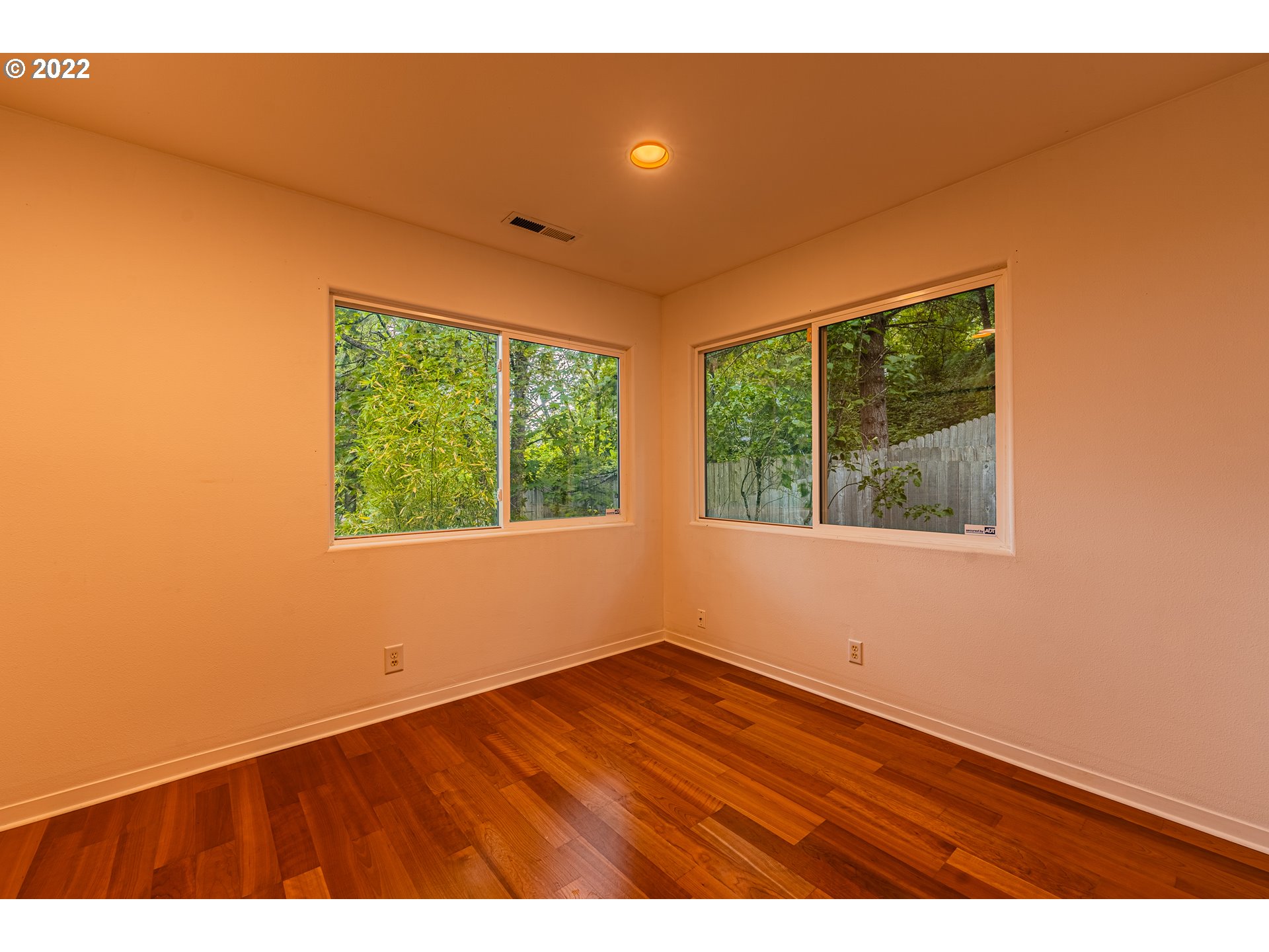 975 Sunset Drive Springfield, OR 97477 - Photo 21 of 30 a view of an empty room with wooden floor and windows