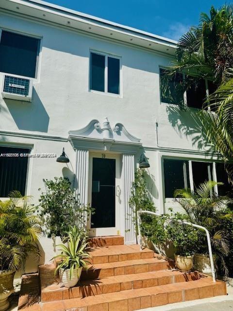 10070 Southeast East Bay Harbor Drive, Unit 70C Bay Harbor Islands, FL 33154 - Photo 2 of 17 a front view of a house with garden