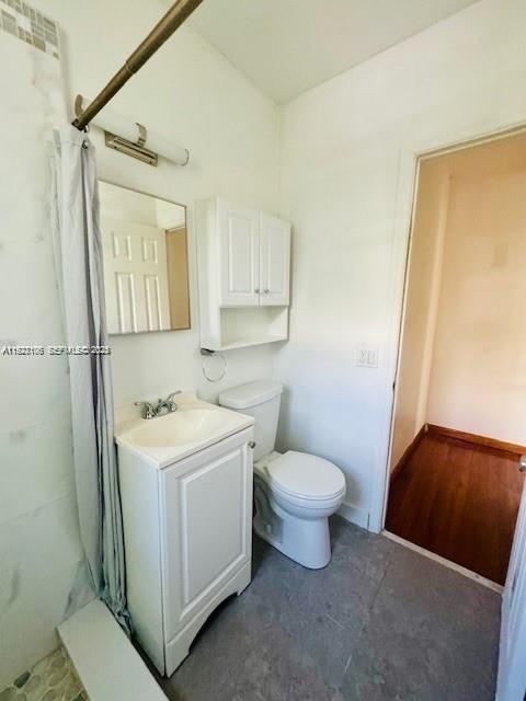 10070 Southeast East Bay Harbor Drive, Unit 70C Bay Harbor Islands, FL 33154 - Photo 7 of 17 a bathroom with a sink toilet and shower