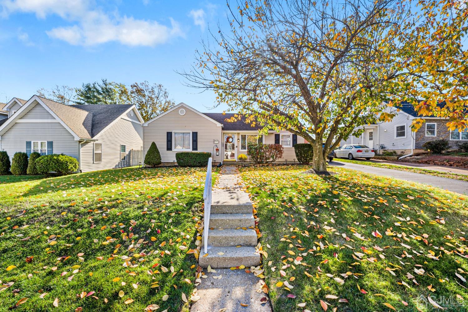 34 Walnut Street Edison, NJ 08817 - Photo 1 of 20 a front view of a house with a garden and trees