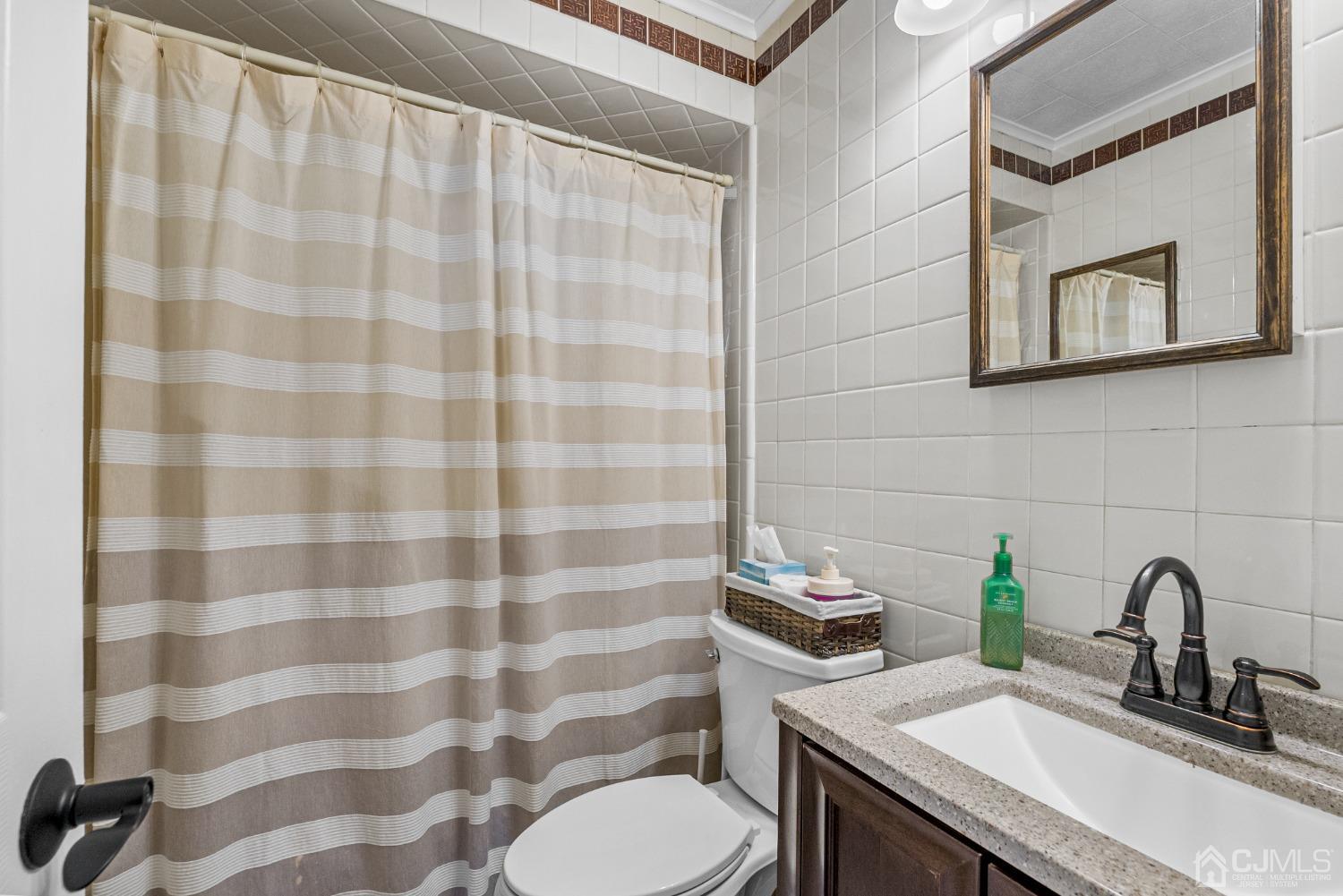 34 Walnut Street Edison, NJ 08817 - Photo 7 of 20 a bathroom with a sink toilet and shower