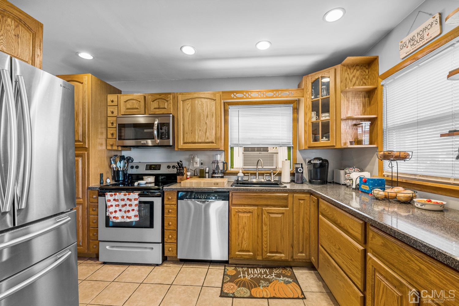 34 Walnut Street Edison, NJ 08817 - Photo 9 of 20 a kitchen with stainless steel appliances granite countertop a stove top oven a sink dishwasher a refrigerator and cabinets with wooden floor