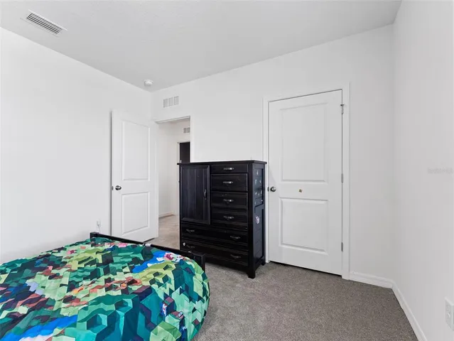 a bedroom with a dresser and a dresser