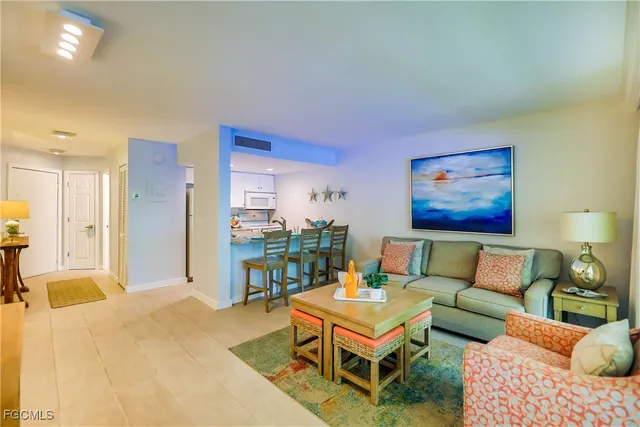 a living room with furniture a rug and a table