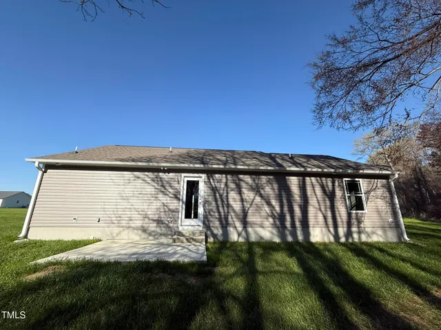 a view of a backyard with wooden fence