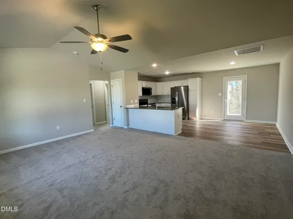 a view of a kitchen with a sink and a refrigerator