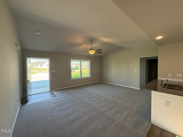 a view of empty room with window and fireplace