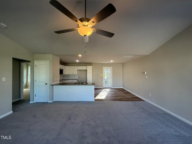 a large kitchen with a large window stainless steel appliances and cabinets