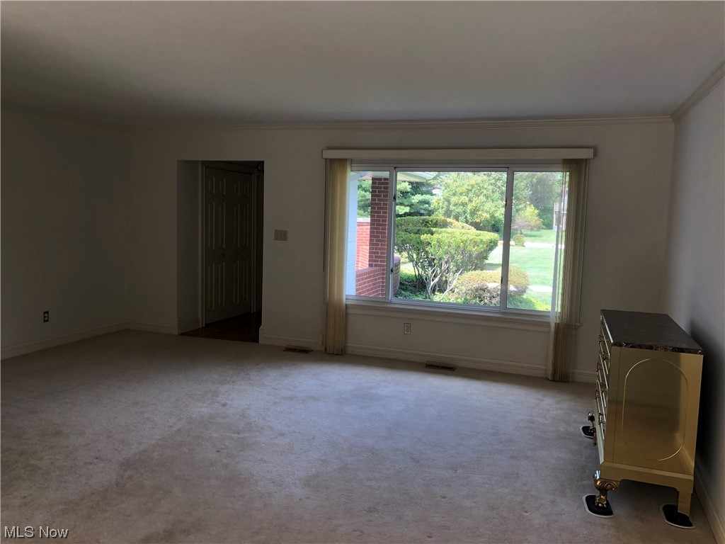 35236 Martin Road Willoughby, OH 44094 - Photo 24 of 35 Carpeted spare room with crown molding