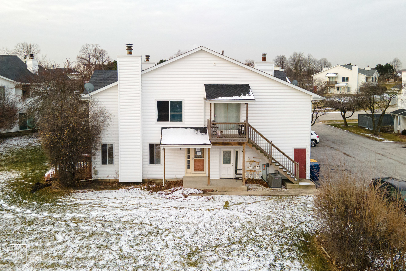45 Churn Road Matteson, IL 60443 - Photo 3 of 14 a white house that has a small yard and a car parked in front of it