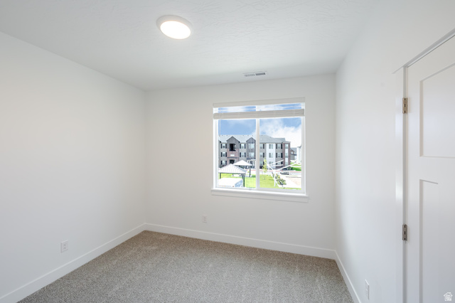 4727 South 690th West, Unit W201 Mapleton, UT 84664 - Photo 5 of 15 Recessed ceiling light fixture, white interior door, window with white trim, and gray carpet flooring