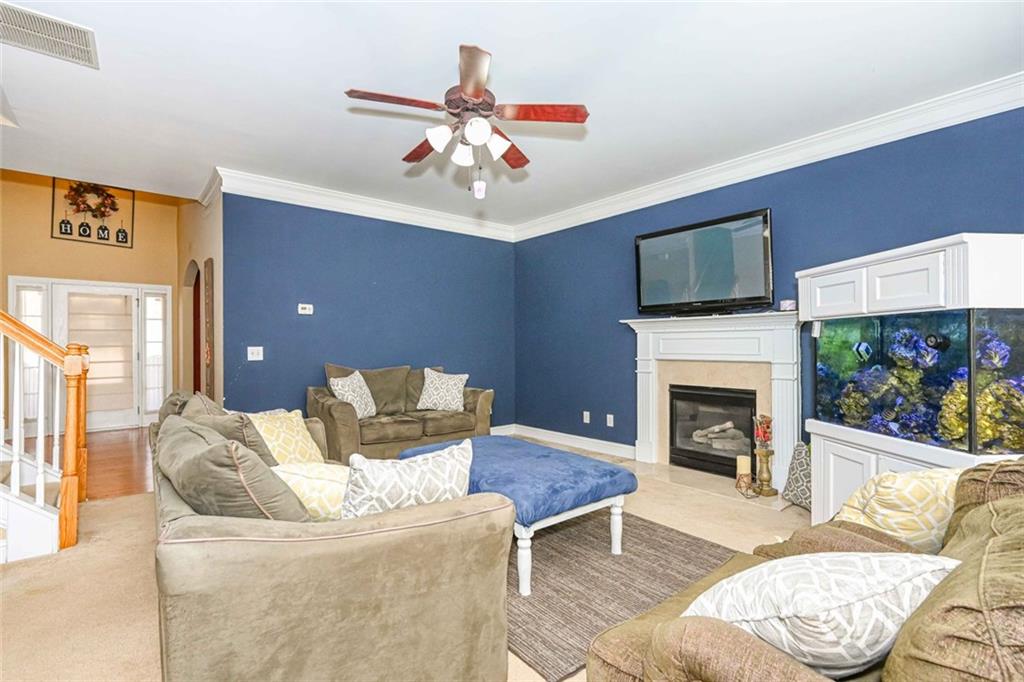 1024 Landon Drive Villa Rica, GA 30180 - Photo 16 of 50 a living room with furniture a flat screen tv and a fireplace