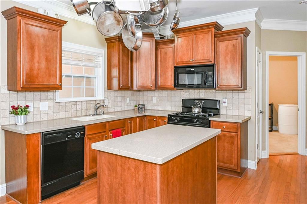 1024 Landon Drive Villa Rica, GA 30180 - Photo 20 of 50 a kitchen with stainless steel appliances granite countertop a sink stove and refrigerator
