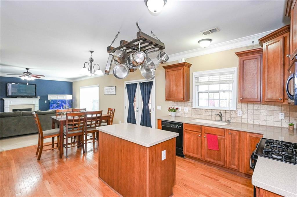 1024 Landon Drive Villa Rica, GA 30180 - Photo 23 of 50 a kitchen with stainless steel appliances granite countertop wooden floors and white cabinets