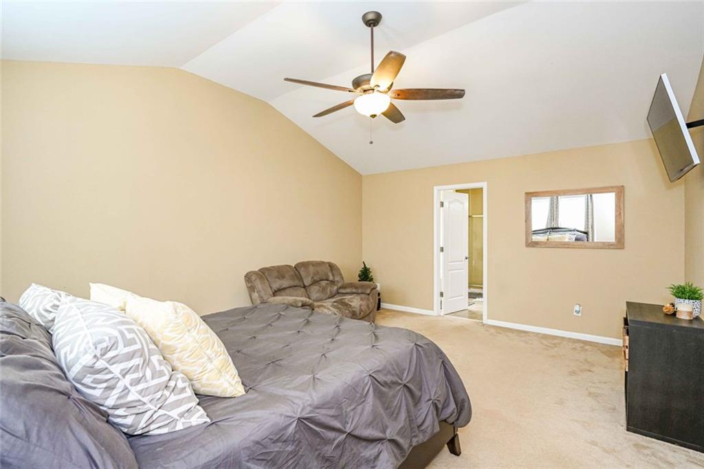 1024 Landon Drive Villa Rica, GA 30180 - Photo 28 of 50 a bedroom with a bed and a chandelier