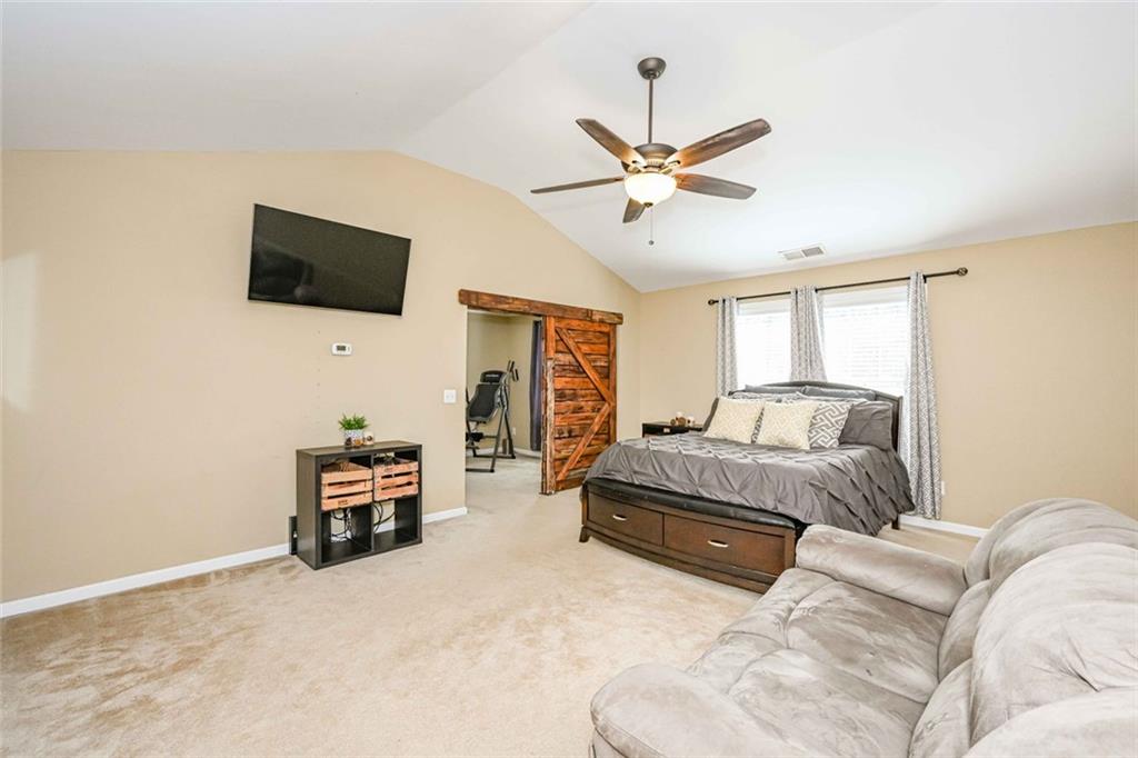 1024 Landon Drive Villa Rica, GA 30180 - Photo 30 of 50 a spacious bedroom with a bed and a flat screen tv