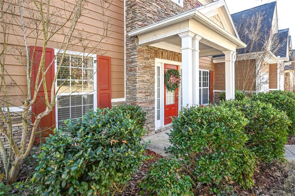 1024 Landon Drive Villa Rica, GA 30180 - Photo 3 of 50 a view of a brick house with a large windows and plants