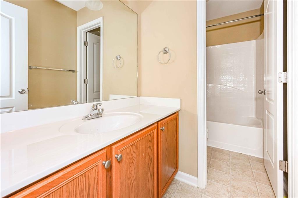 1024 Landon Drive Villa Rica, GA 30180 - Photo 39 of 50 a bathroom with a granite countertop sink and a mirror