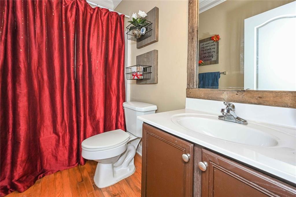 1024 Landon Drive Villa Rica, GA 30180 - Photo 44 of 50 a bathroom with a sink a toilet and shower curtain