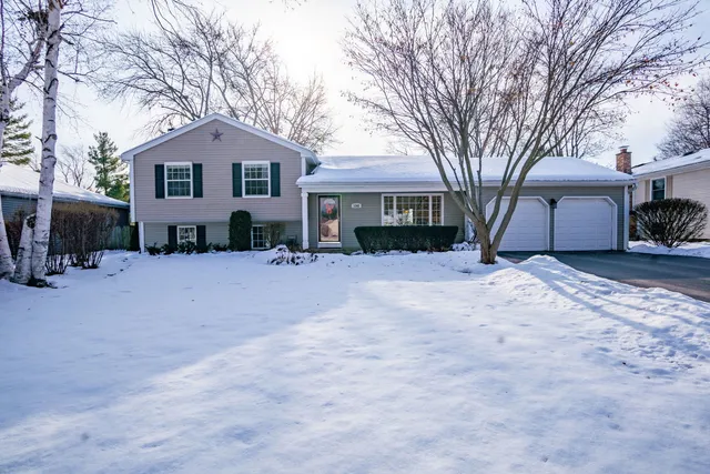 a view of a house with a yard covered in snow