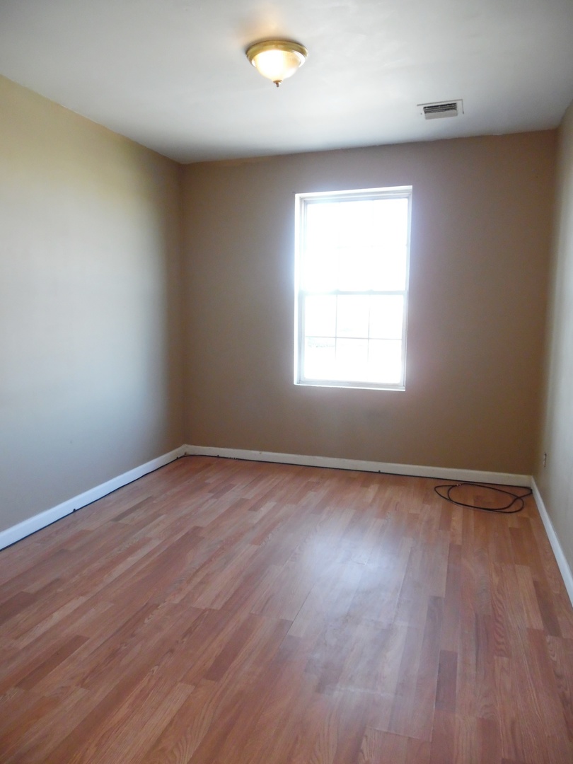2300 Highway 23 Grand Ridge, IL 61325 - Photo 10 of 13 an empty room with wooden floor and windows