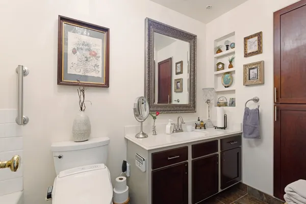 a bathroom with a toilet sink and mirror